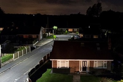 Image of a house and LED street lighting, taken at night.